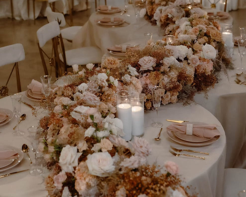 Earthy pastel wedding reception with blush and neutral floral arrangements, candlelight, and elegant table settings in Miami