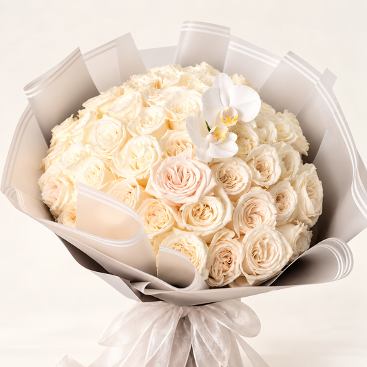 Luxury ivory rose bouquet with white orchids and elegant neutral wrapping by AG Floral Studio in Miami