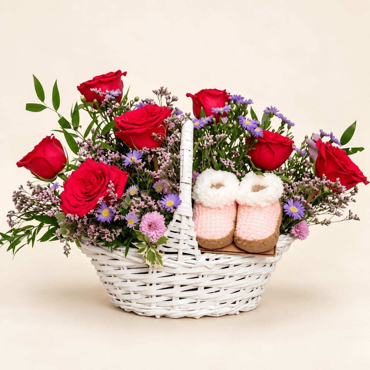 The Little Bloom baby flower basket with hot pink roses, soft pink and lavender flowers, and pink baby booties
