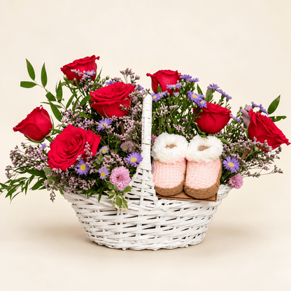 The Little Bloom baby flower basket with hot pink roses, soft pink and lavender flowers, and pink baby booties