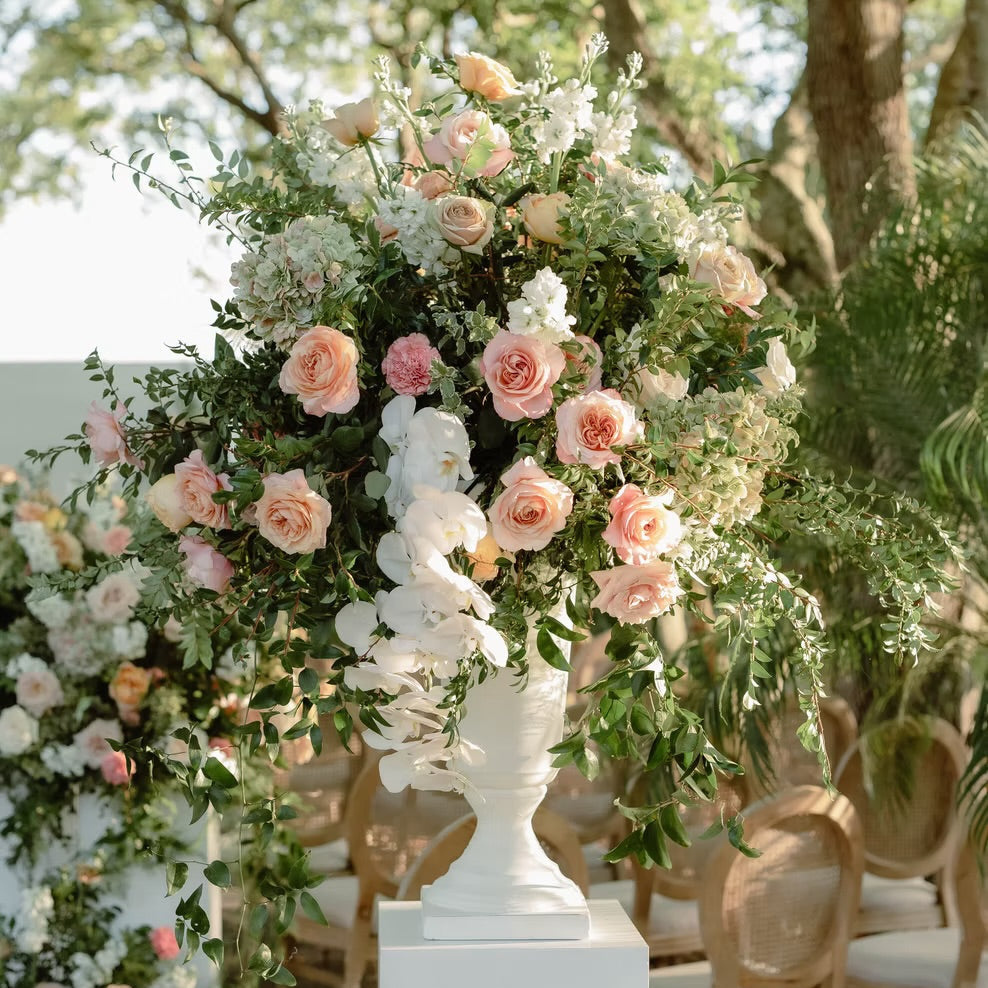Floral archway with pink and white flowers in an outdoor setting