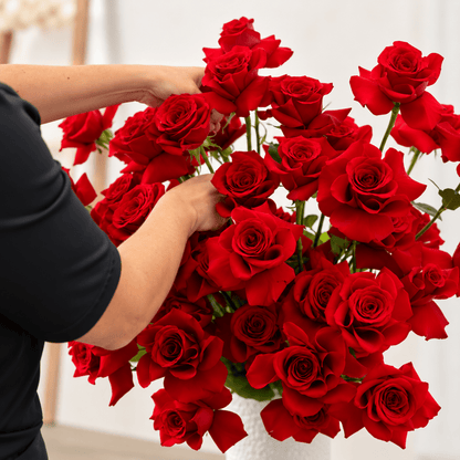 Florist arranging premium red roses for The Midnight Tango red rose arrangement