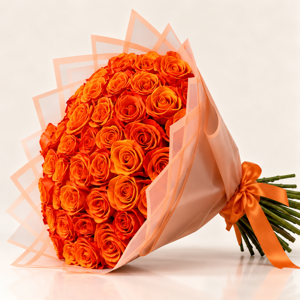 Luxury orange rose bouquet with peach wrapping by AG Floral Studio in Miami