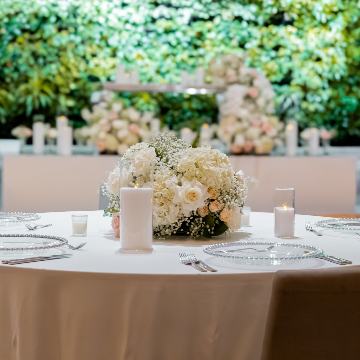 Decorated table with floral centerpiece and place settings outdoors