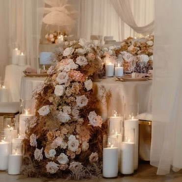 Decorative indoor setting with tables, chairs, and floral arrangements.