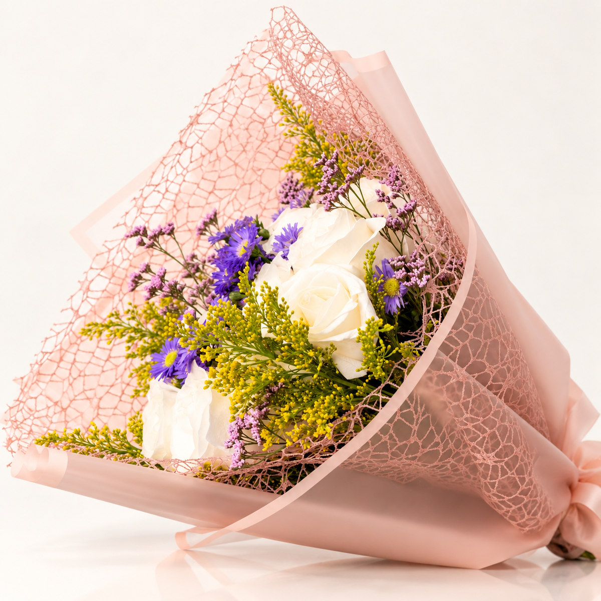 White roses with purple flowers and blush pink wrapping by AG Floral Studio in Miami
